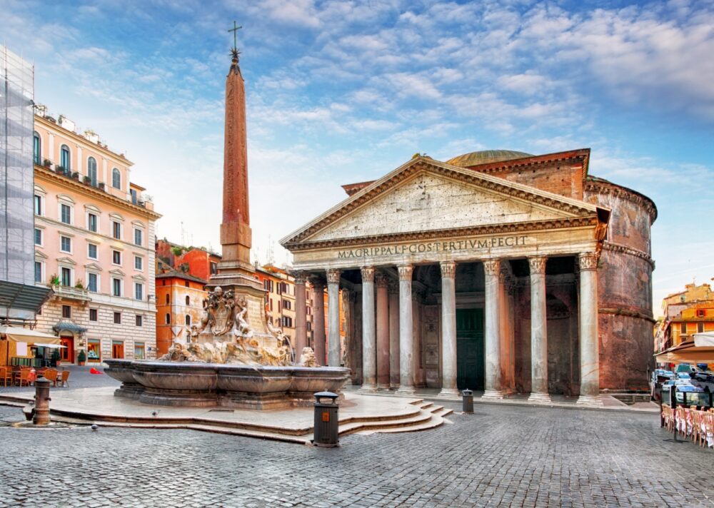 Classical Corinthian columns of the Pantheon behind the stone fountain and obelisk on Piazza della Rotonda in Rome, Italy