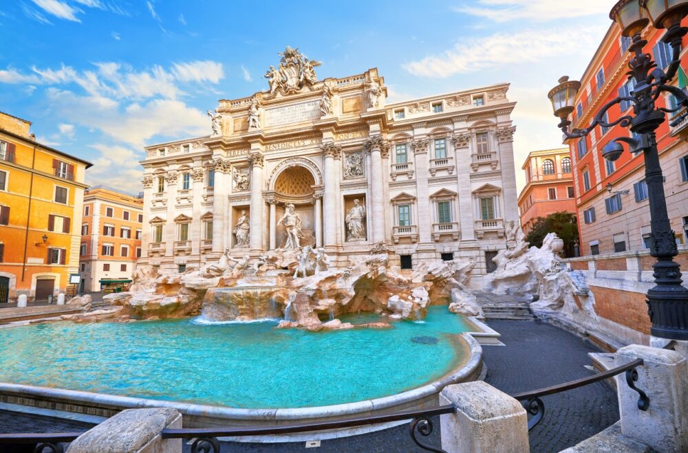 Baroque marble sculptures of Oceanus and turquoise water basin at the Trevi Fountain in Rome, Italy